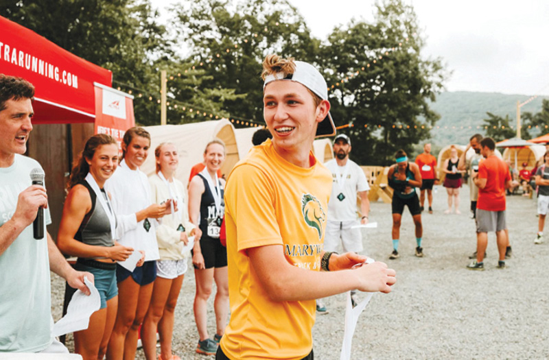 A young man wearing a backwards hat and Maryood T-shirt.